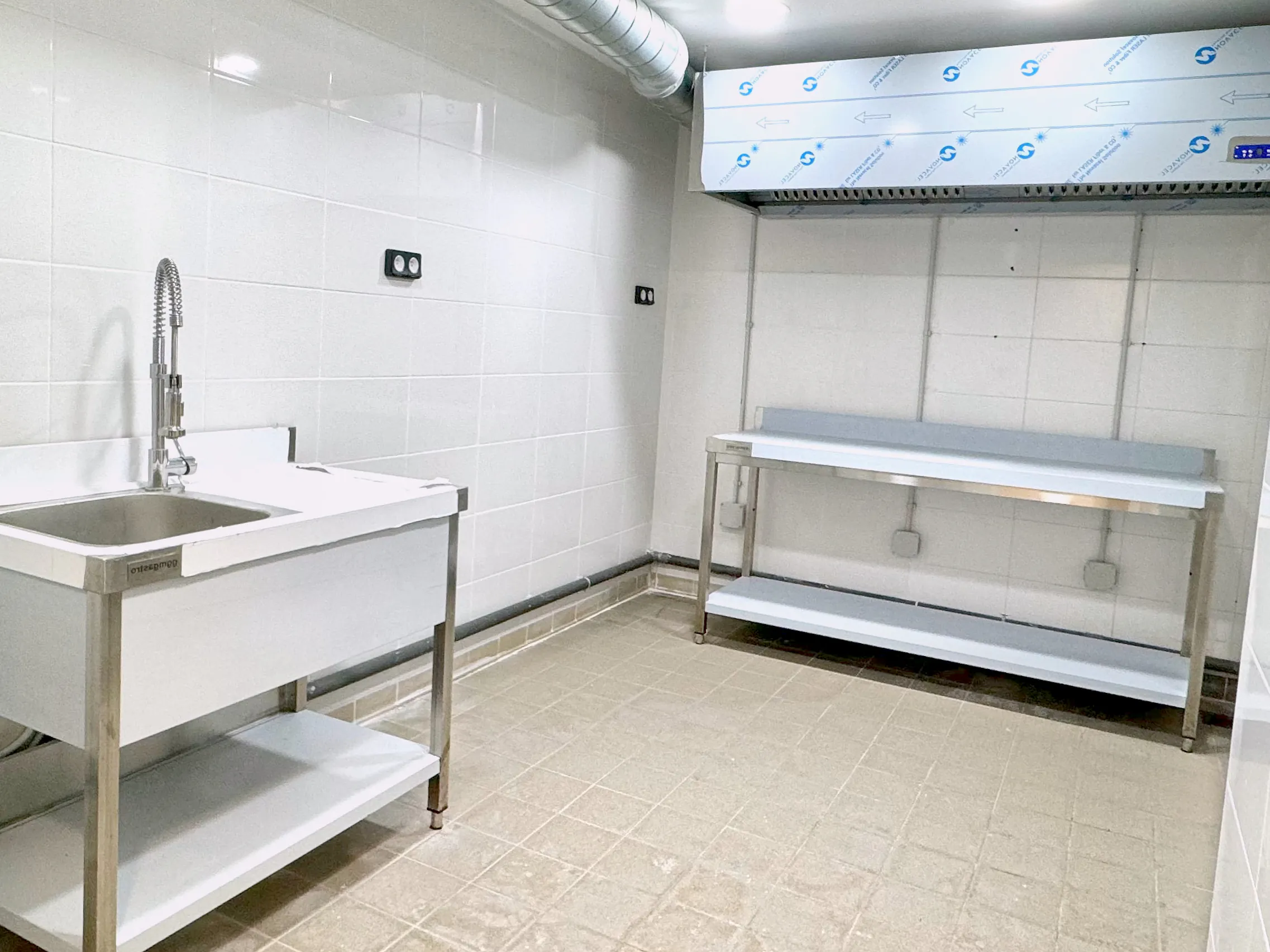 Plonge inox avec douchette de prélavage et table inox dans un laboratoire Hub Kitchen
