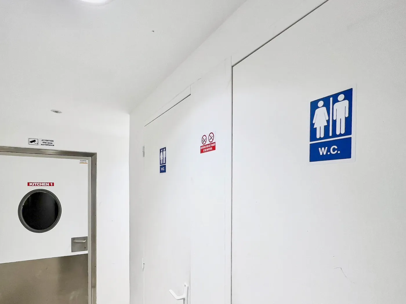 Parties communes d'un site Hub Kitchen : sanitaires et porte de laboratoire à hublot